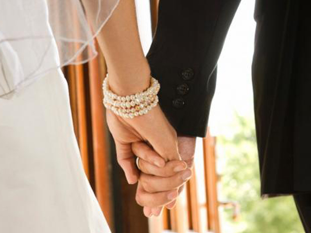 Bride and Groom holding hands